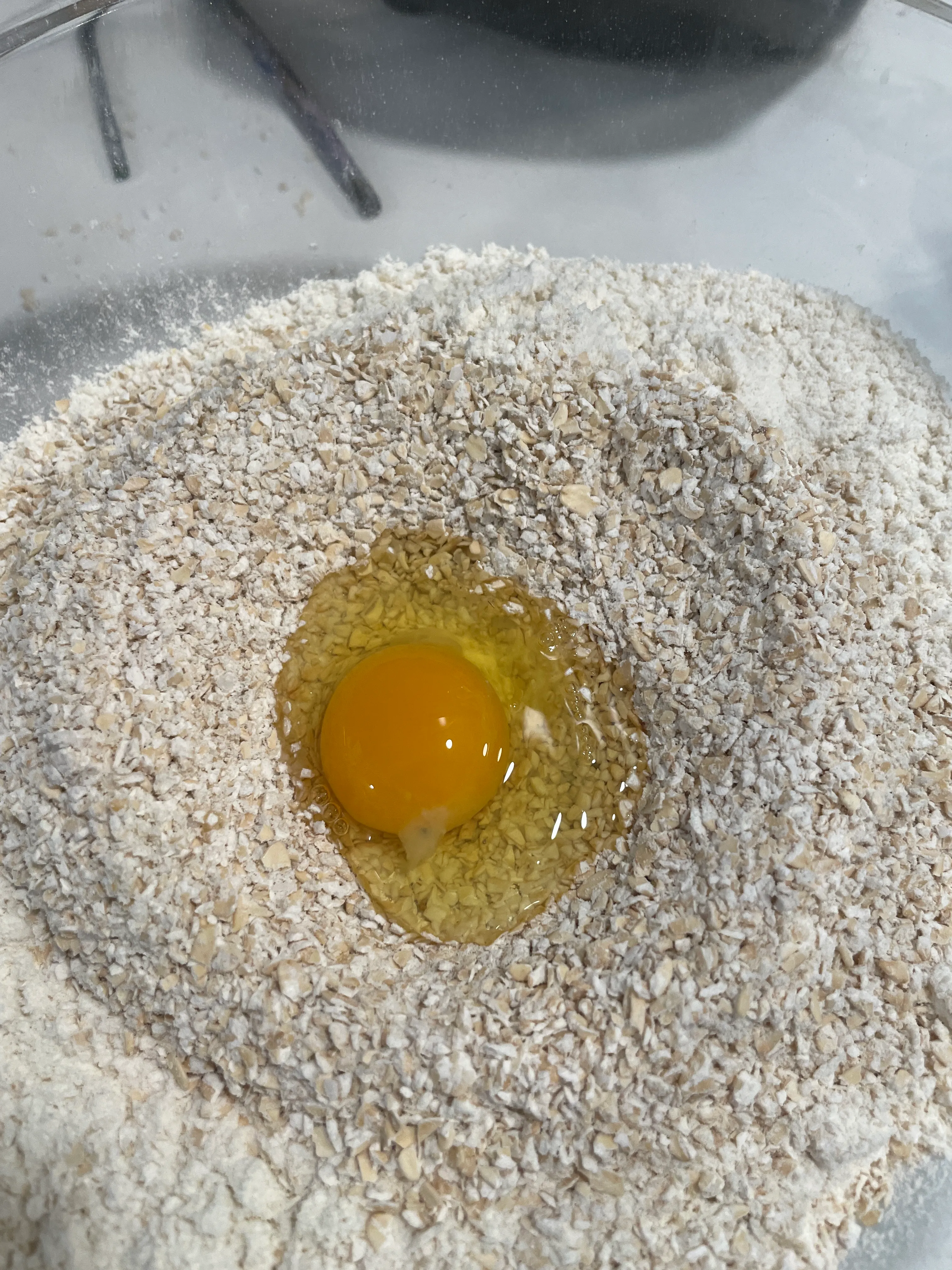 Fresh egg cracked into flour for baking